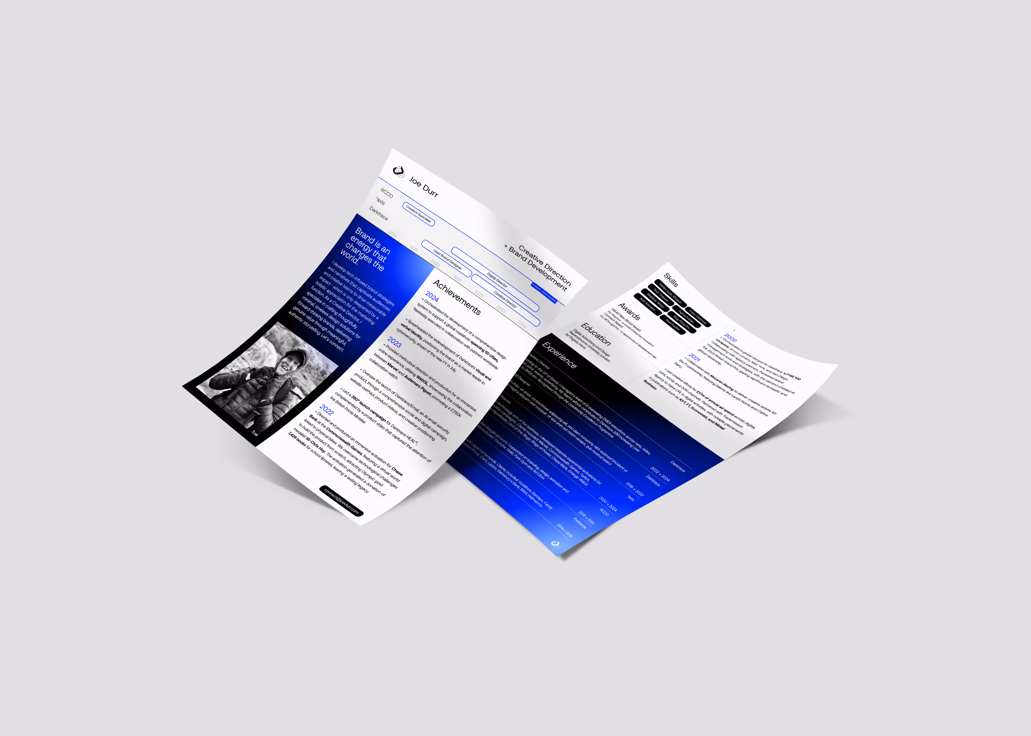 Open tri-fold resume for Joe Durr with blue gradient sections, photo of smiling person, and headings like achievements and experience.